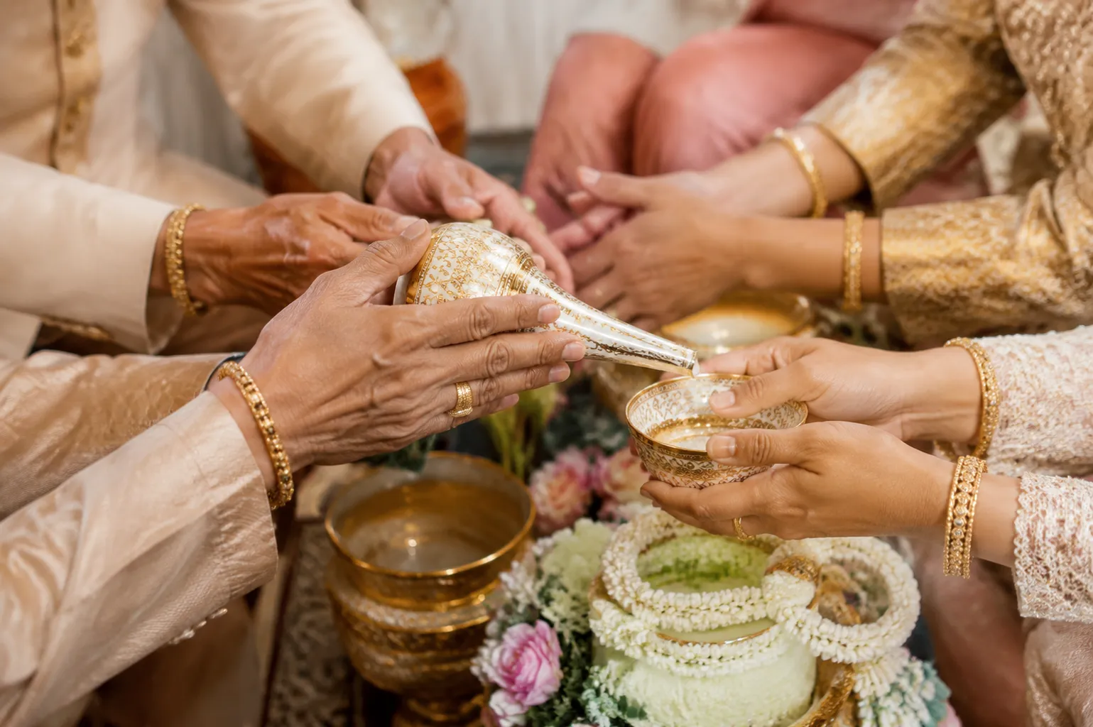 Close detail of hands presenting Thai wedding ceremony accessories during use