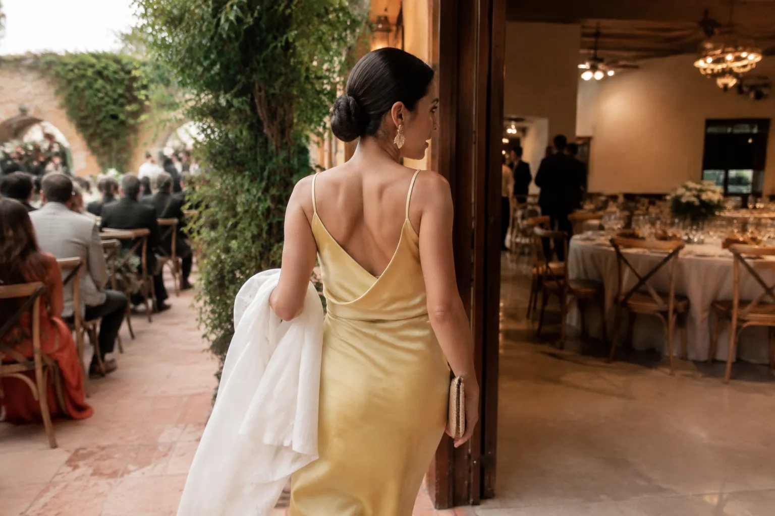 Wedding guest moving between an outdoor ceremony area and an indoor reception with a removable layer